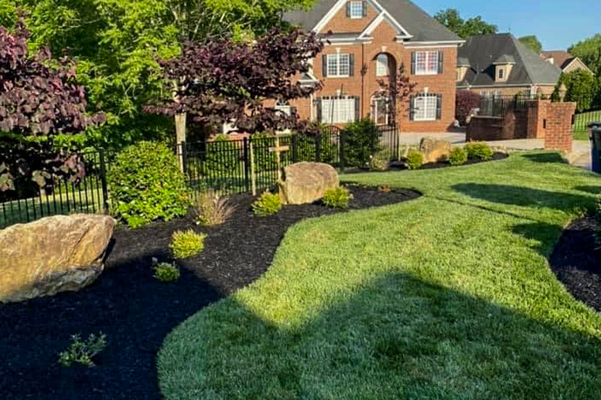 a drone image of a hard landscaping project, featuring shrubs, bushes, and stone work.